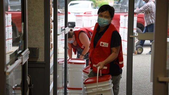 Red Cross volunteers help load supplies