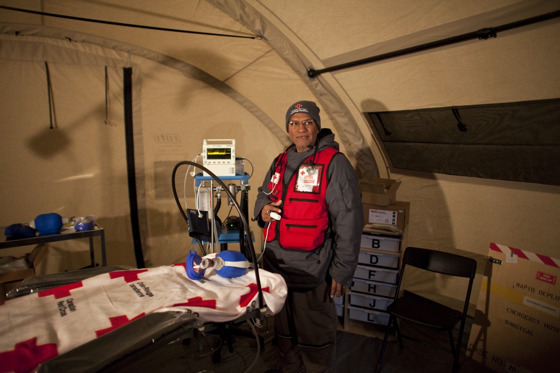 A Red Cross delegate shows the inside of the tent, part of the Emergency Response Unit, where operations can be performed. / Photo credit: Johan Hallberg-Campbell
