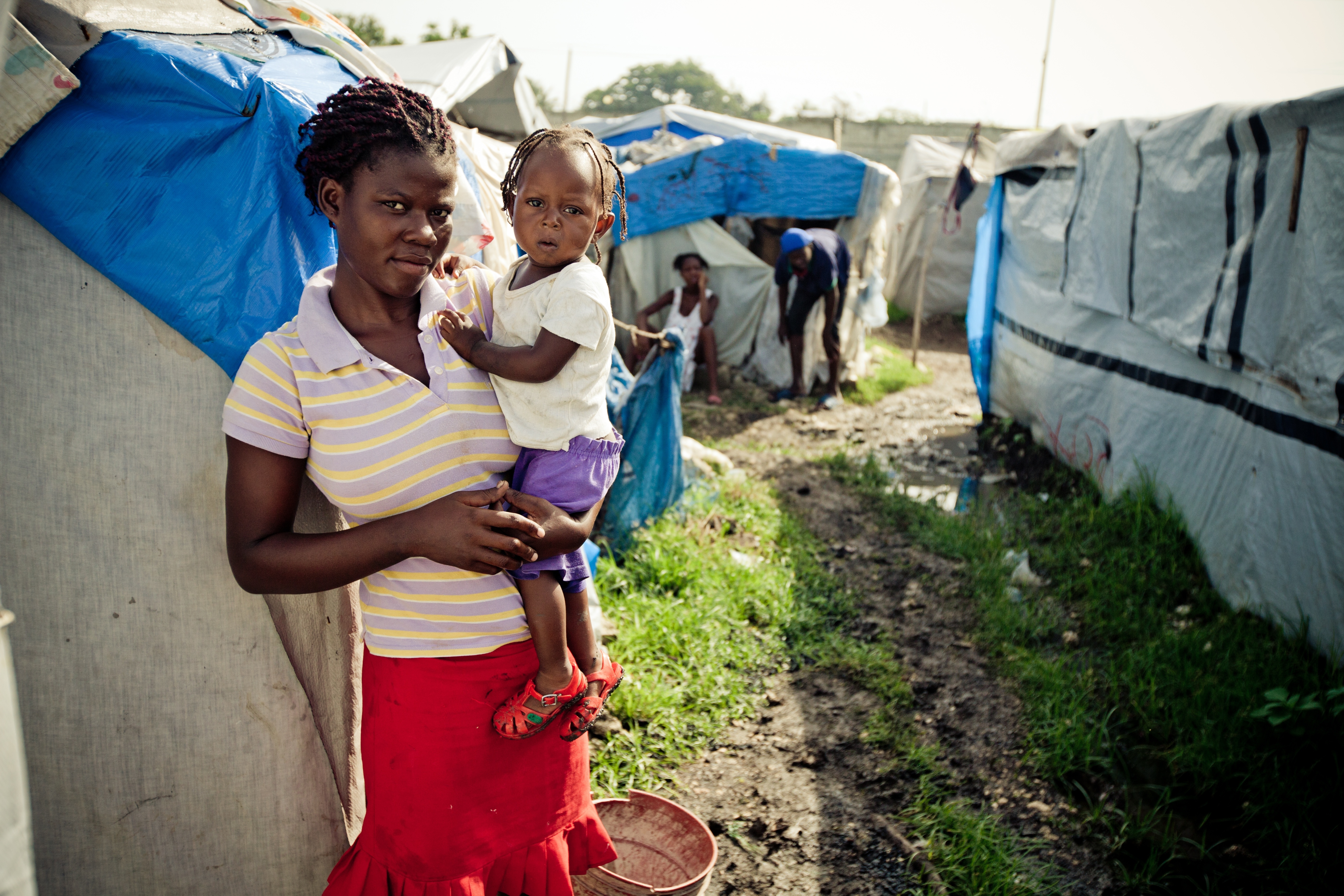 Célimène Vilaseau and her daughter in front of her tent in the camp Annexe de la Mairie in Port-au-Prince