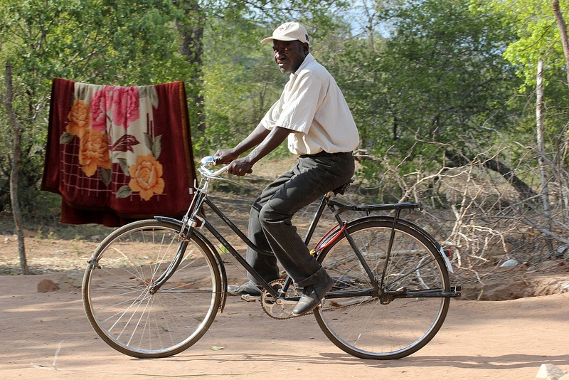 Zimbabwe volunteer on bicycle