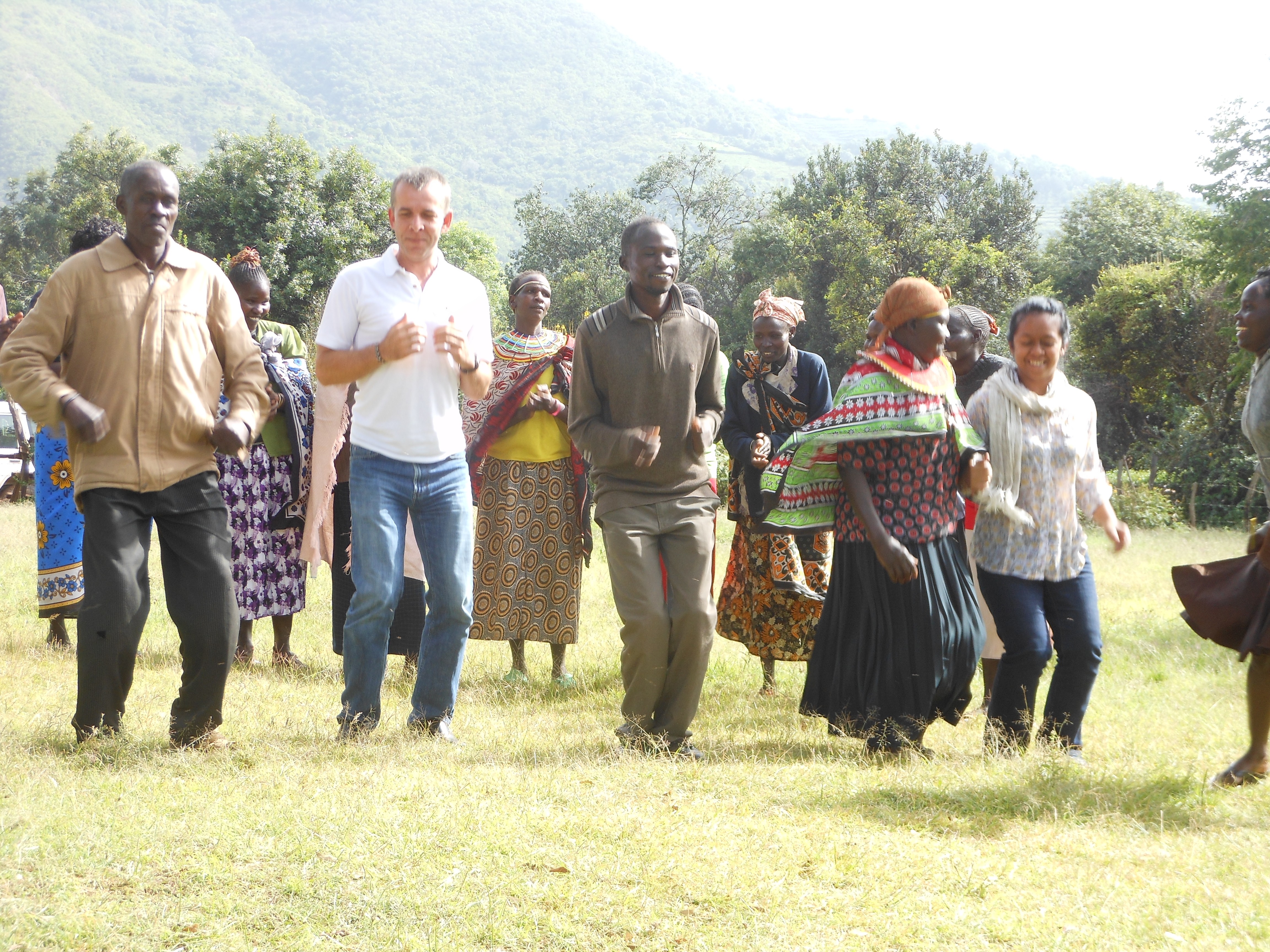 Tahina (r) participating in a dance party during a visit in Kenya