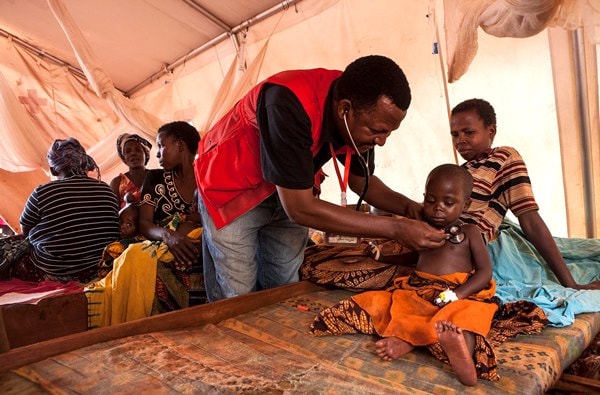 A doctor with the Tanzania Red Cross provides care to a young child