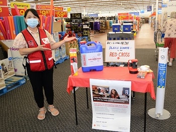 Canadian Red Cross volunteer and Walmart Ambassador Ha Vu, pictured with Walmart associate Nicholes Buksinski in front of a campaign sign at the Dartmouth Crossing store in Nova Scotia.