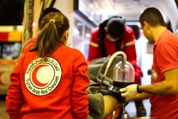 SARC volunteers help evacuate civilians during conflict