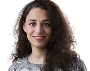 A woman smiling at the camera with white background