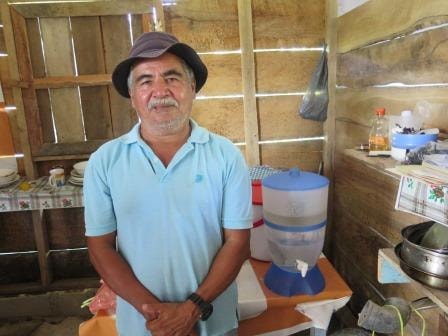 Jacinto Martinez Mendez stands beside the water purifier he received