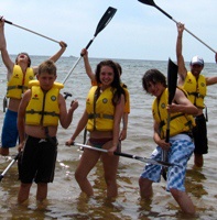 Children with oars in the water at a Canadian Red Cross Water Safety Day Camp