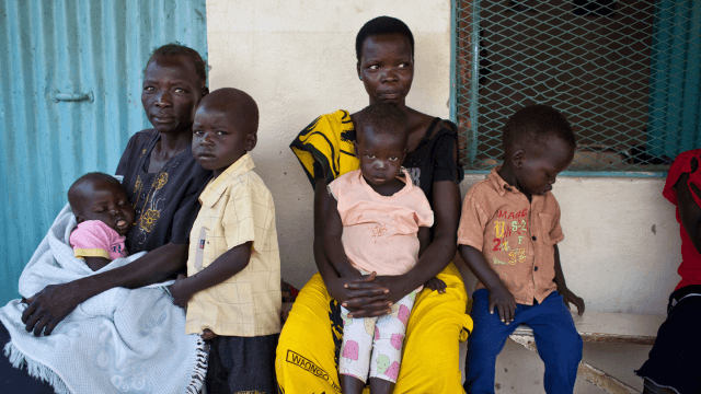 Mothers and their children waiting outside to be seen by health professionals in Sudan