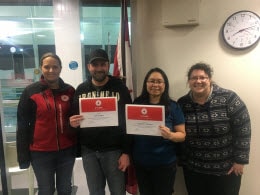 Red Cross staff Cailin Hodder and Annie Papadakis (far left and far right) present 5 year milestone awards to Red Cross volunteers Jae Redfern and Madeleine Redfern