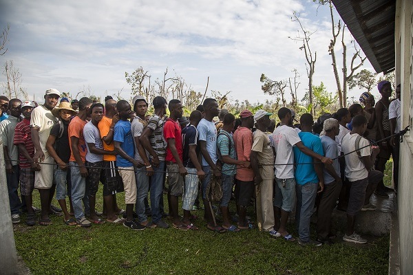 People line up for shelter toolkit distribution site at Arniquet, Antoine, Haiti