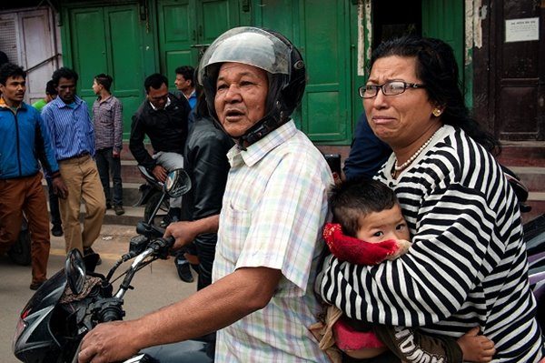 Family on a motorcycle on a street in Nepal