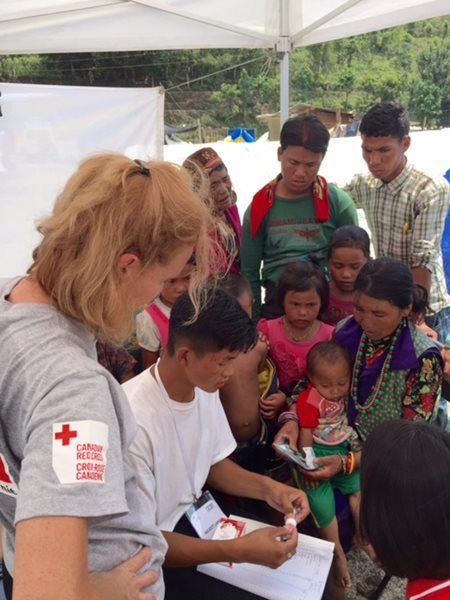 Grandmother Norchi Tamang baby Anuraj with Red Cross translator and nurse