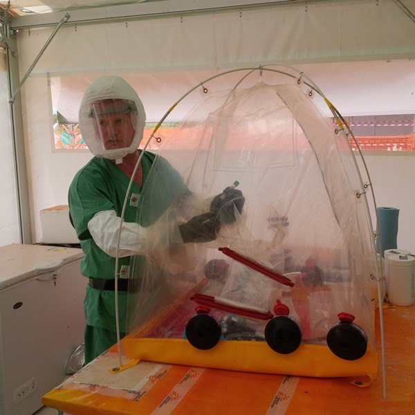 worker demonstrates testing for Ebola with blood samples
