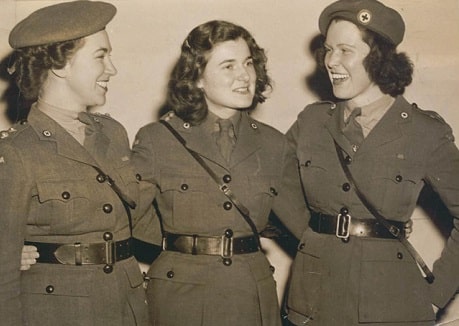An old black and white photo of three women in Red Cross uniforms in the 40s.