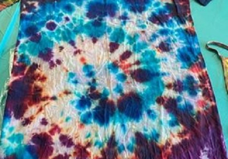 Close up of a tie-dyed t-shirt in various colours