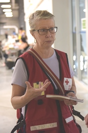 Red Cross volunteer Louise Hodder wearing a Red Cross vest