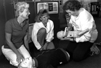 A Red Cross instructor delivering a first aid course to two women in 1987