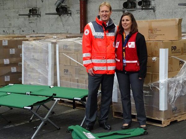Lise Anne Pierce from the Canadian Red Cross with the cots shipped to the German Red Cross