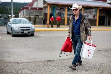 Everett Lightfoot walks with his cleanup kit