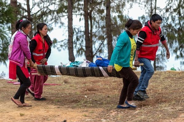Red Cross volunteers act out an emergency scenario in Okhaldhunga District as part of a First Aid training exercise