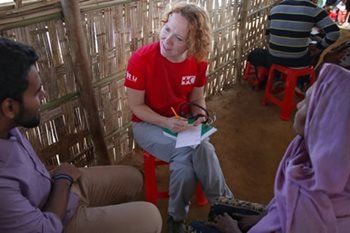 Sherry Humphrey, a registered nurse, sits next to her translator on a short red stool as the pair works out why Halima came to the clinic.