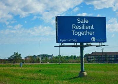 A sign says "safe, resilient, together" in Fort McMurray