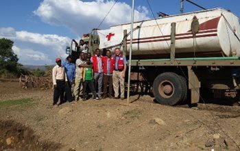 People were coming from four to five kilometers away filling up bright plastic water containers with the fresh clean water provided by the Red Cross water truck.