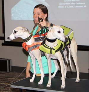 Christine with two dogs in lifejackets