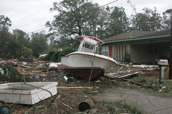 A boat washed to land, on a home's front lawn, during a severe hurricane.
