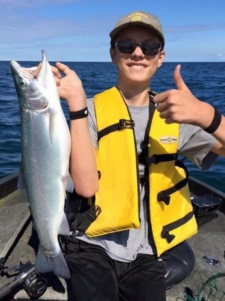 Sporting his lifejacket and a nice rainbow trout!
