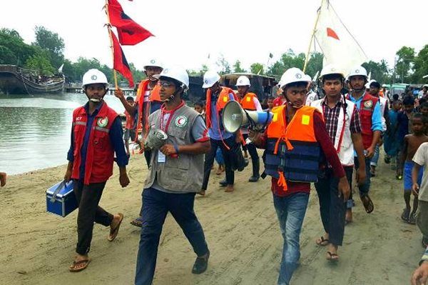 Bangladesh Red Crescent Cyclone Preparedness Programme volunteers warn communities in coastal communities to evacuate to safety as Cyclone Mora makes landfall