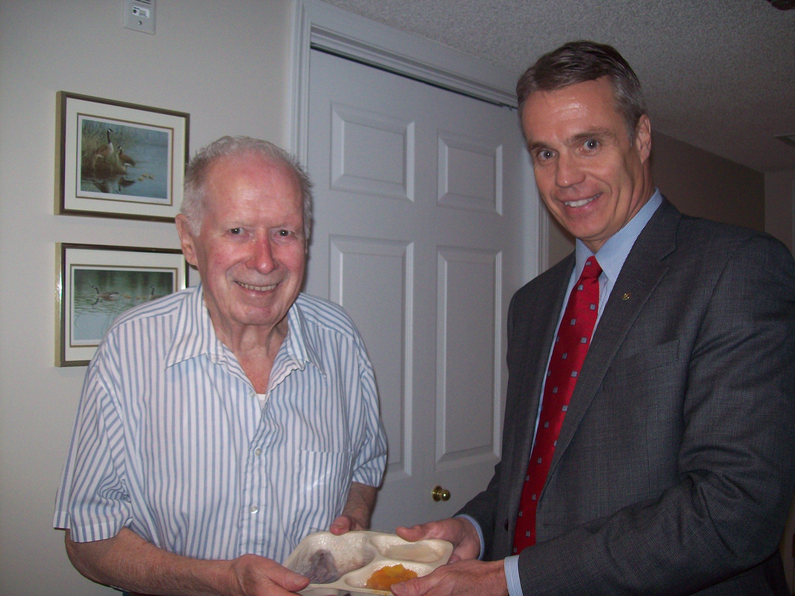 Burlington Mayor Rick Goldring delivers a meal to client John Gascho