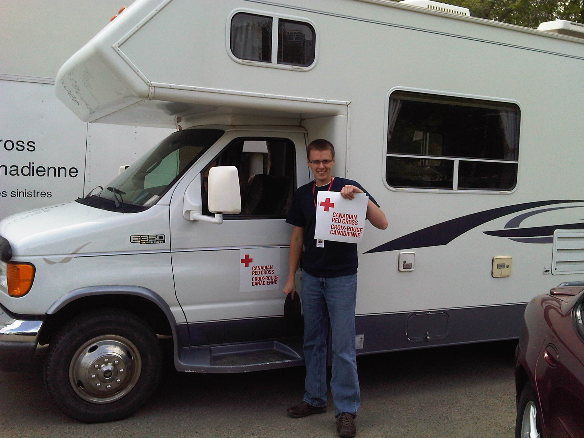 Logistics and first aid keep volunteer Aaron van Nostrand busy during the royal visit in Slave Lake, Alberta