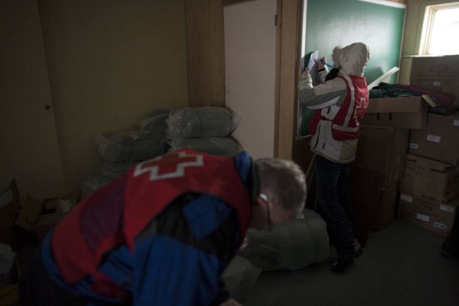 Red Crossers preparing to distribute more supplies, including sleeping bags