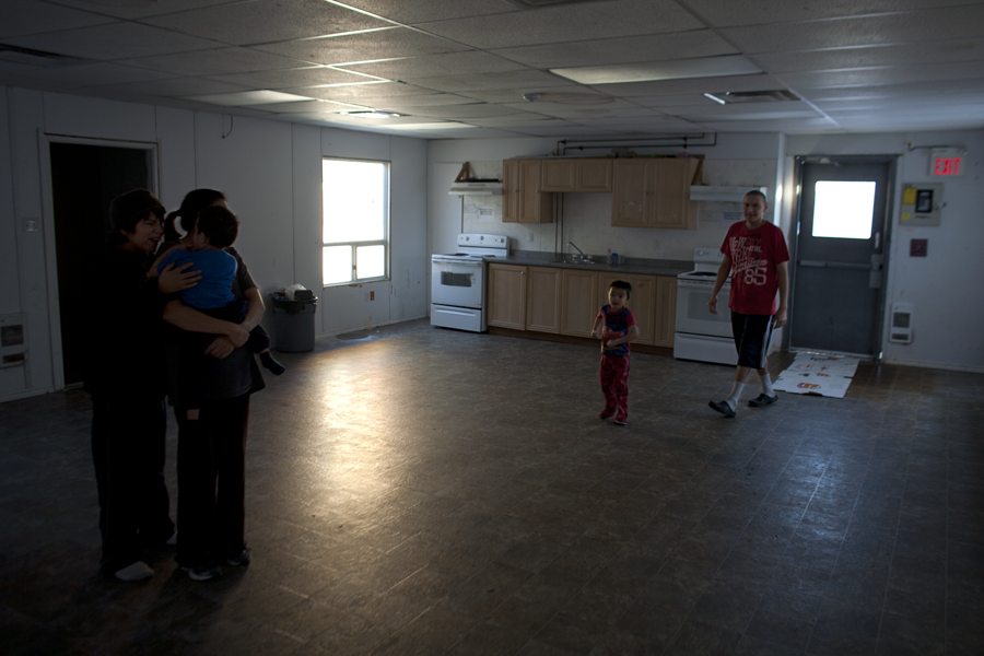 A family in a housing shelter. Red Cross brought sleeping bags for families