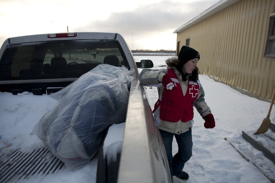 Jen, a Red Cross volunteer from Timmins, loading up sleeping bags