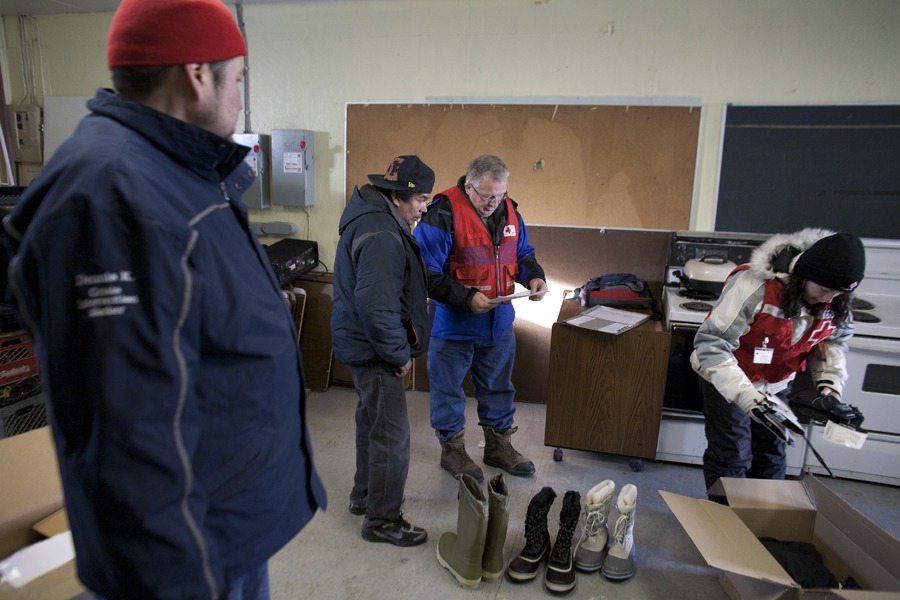 Red Cross volunteer Jim Lanthier from Timmins shown here in the red vest is preparing to deliver supplies