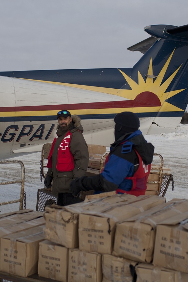 Volunteer Mike Grant unloading a plane load of supplies 