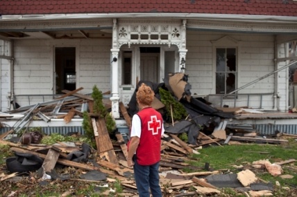 A Canadian Red Cross volunteer surveys the damage caused by a tornado in Goderich, Ontario. Photo by Johan Hallberg-Campbell.