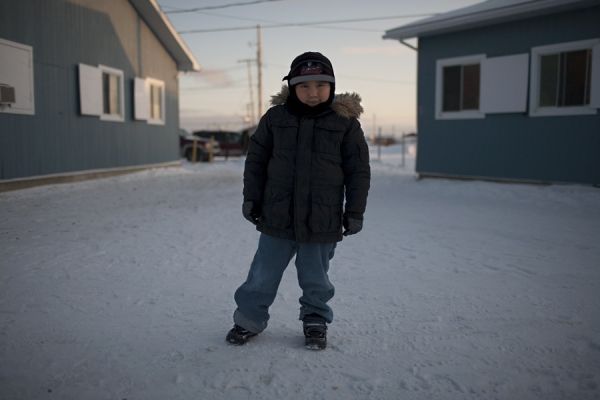 Little boy standing outside in the winter