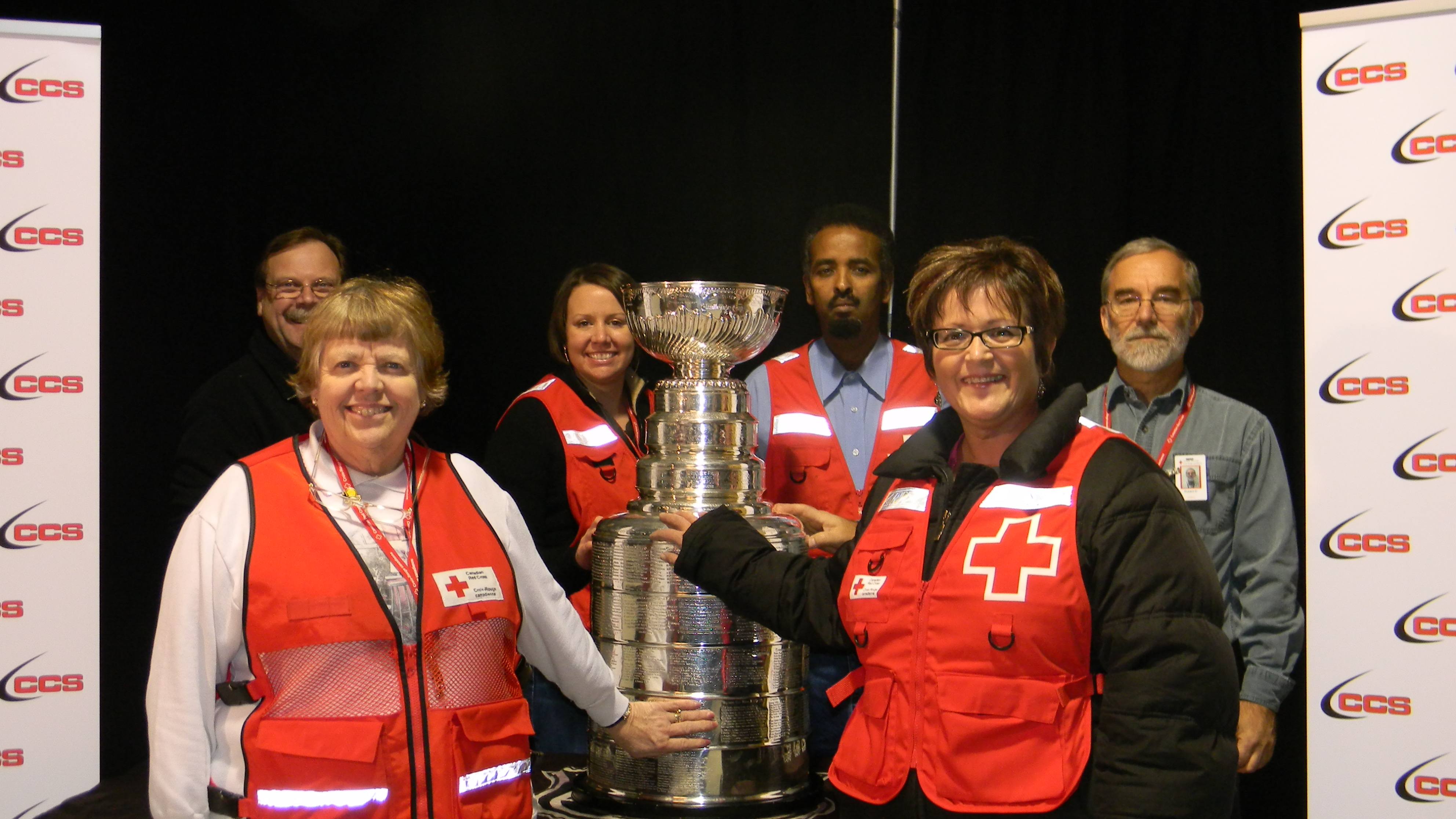 Red Cross personnel working in Slave Lake, Alberta pose with the Stanley Cup.