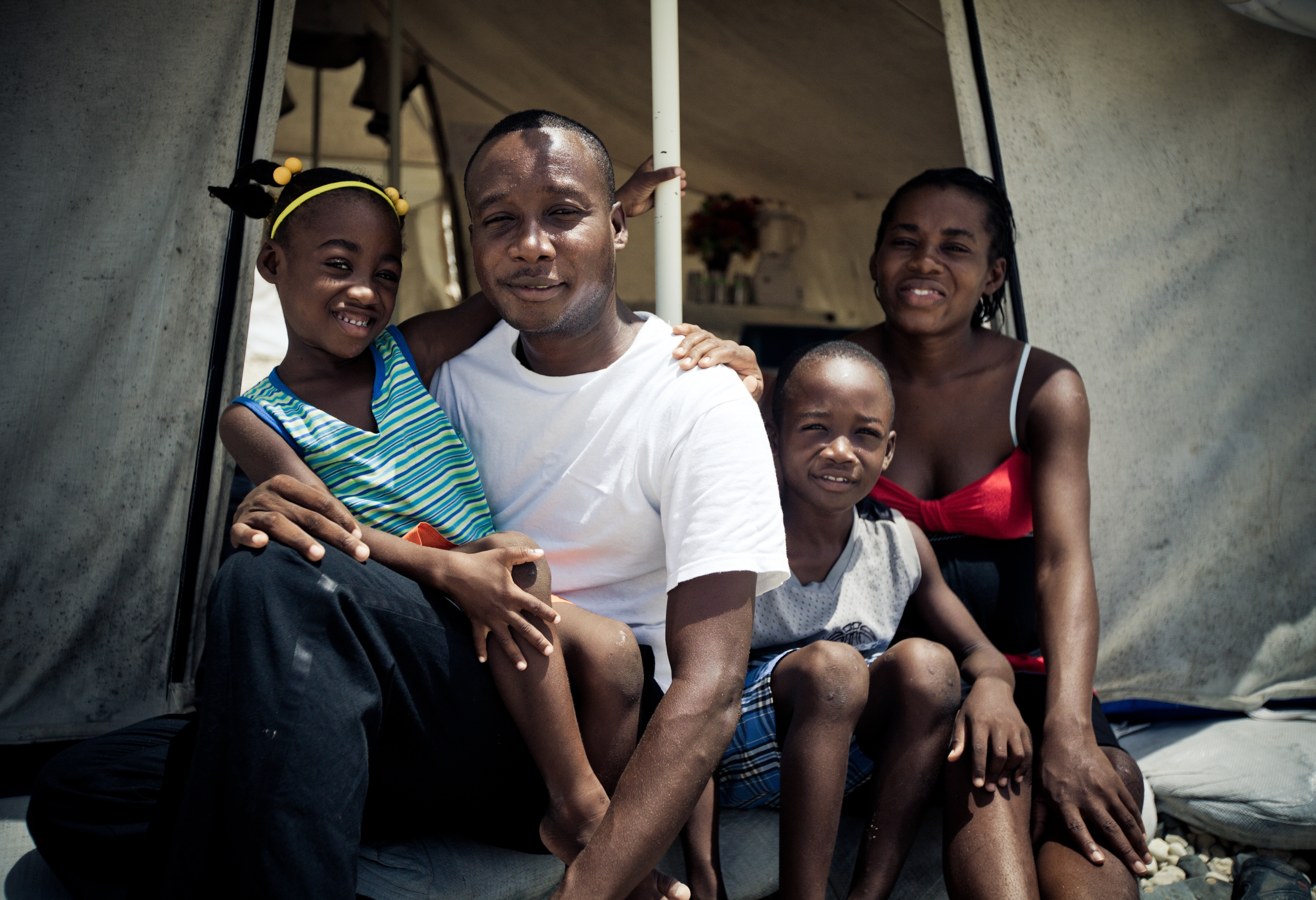 Familly Barthélémy, from left to right: Kemehise Ange, 4 years old, Pastor Manès, Max Andrew, 8 years old and Luciana. They live in camp Tabarre Issa in Port-au-Prince since their house collapsed on the 12th of January.