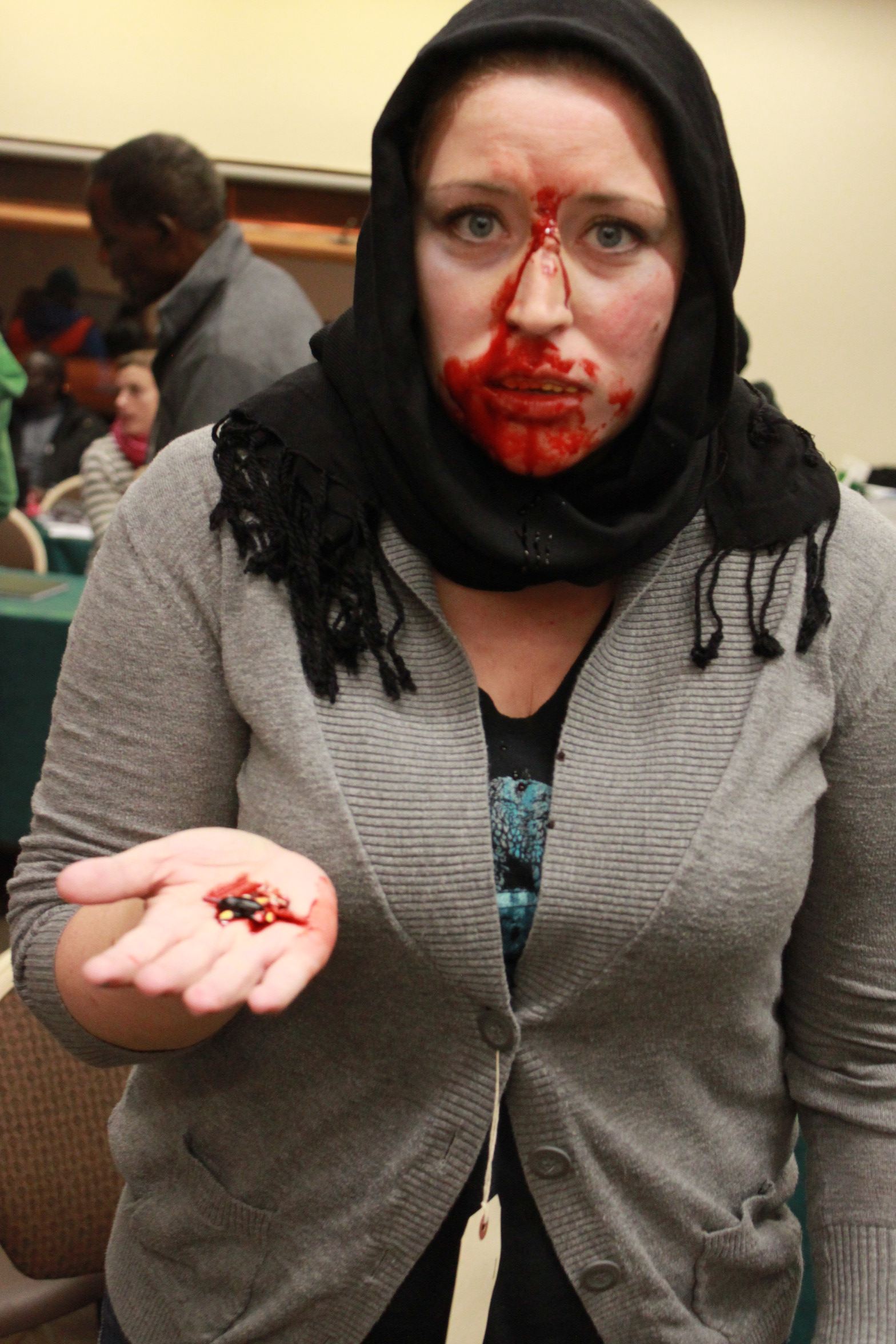The final costume! She is holding teeth that have been knocked out. The victims are made to appear as real as possible.
