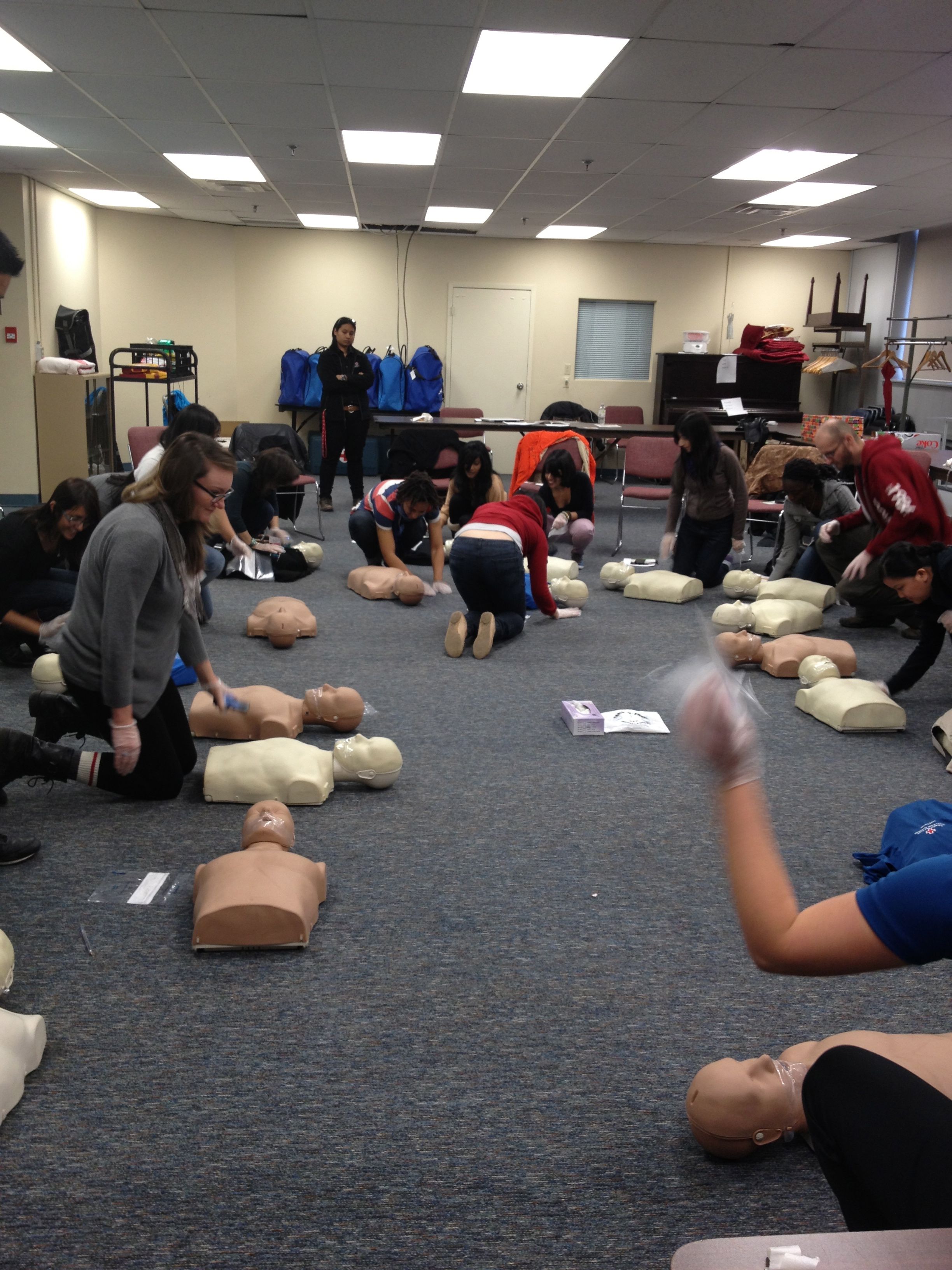 The rest of the class practices CPR on their dummies