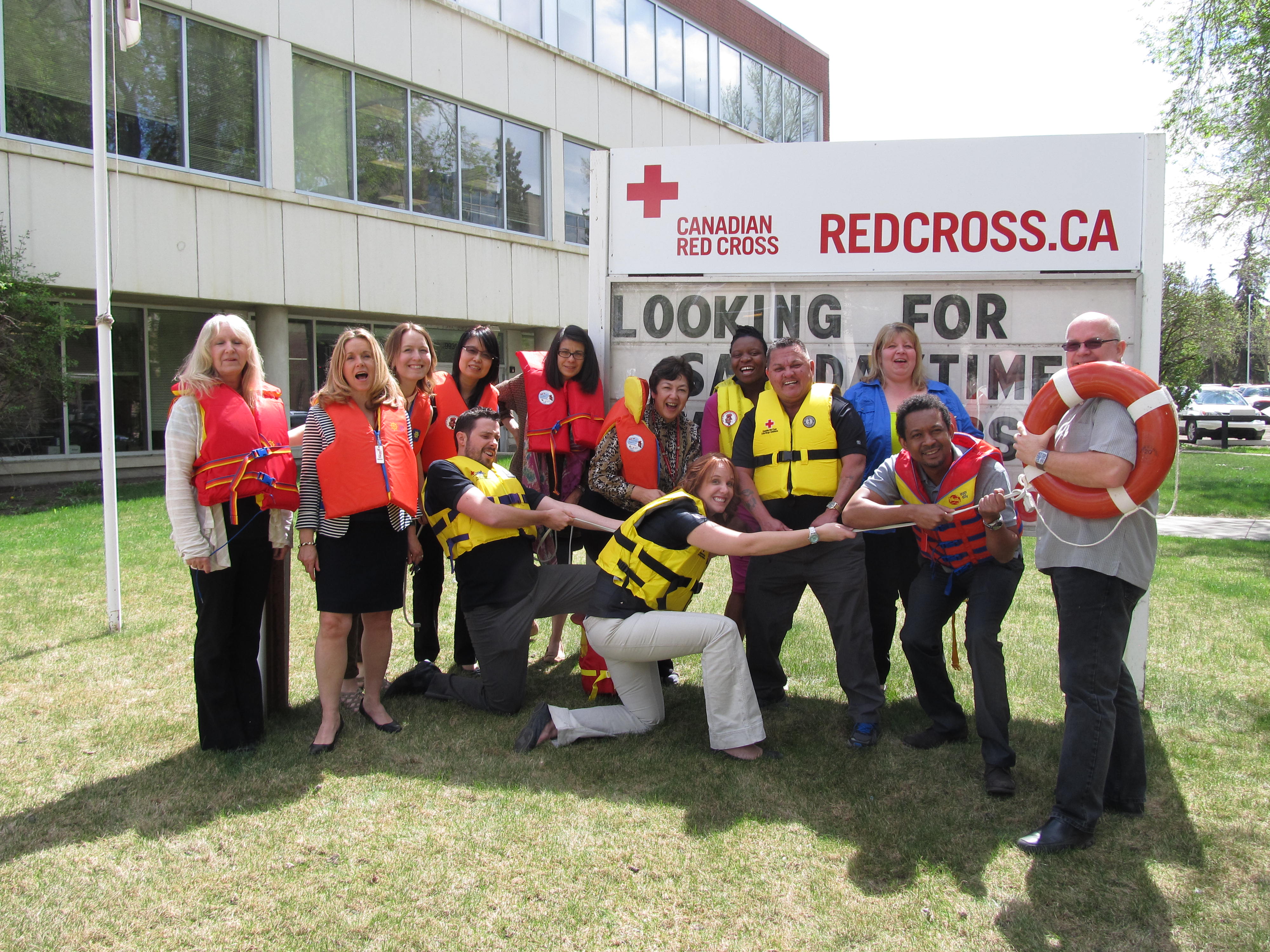 Red Cross office in Edmonton sports their lifejackets at work.