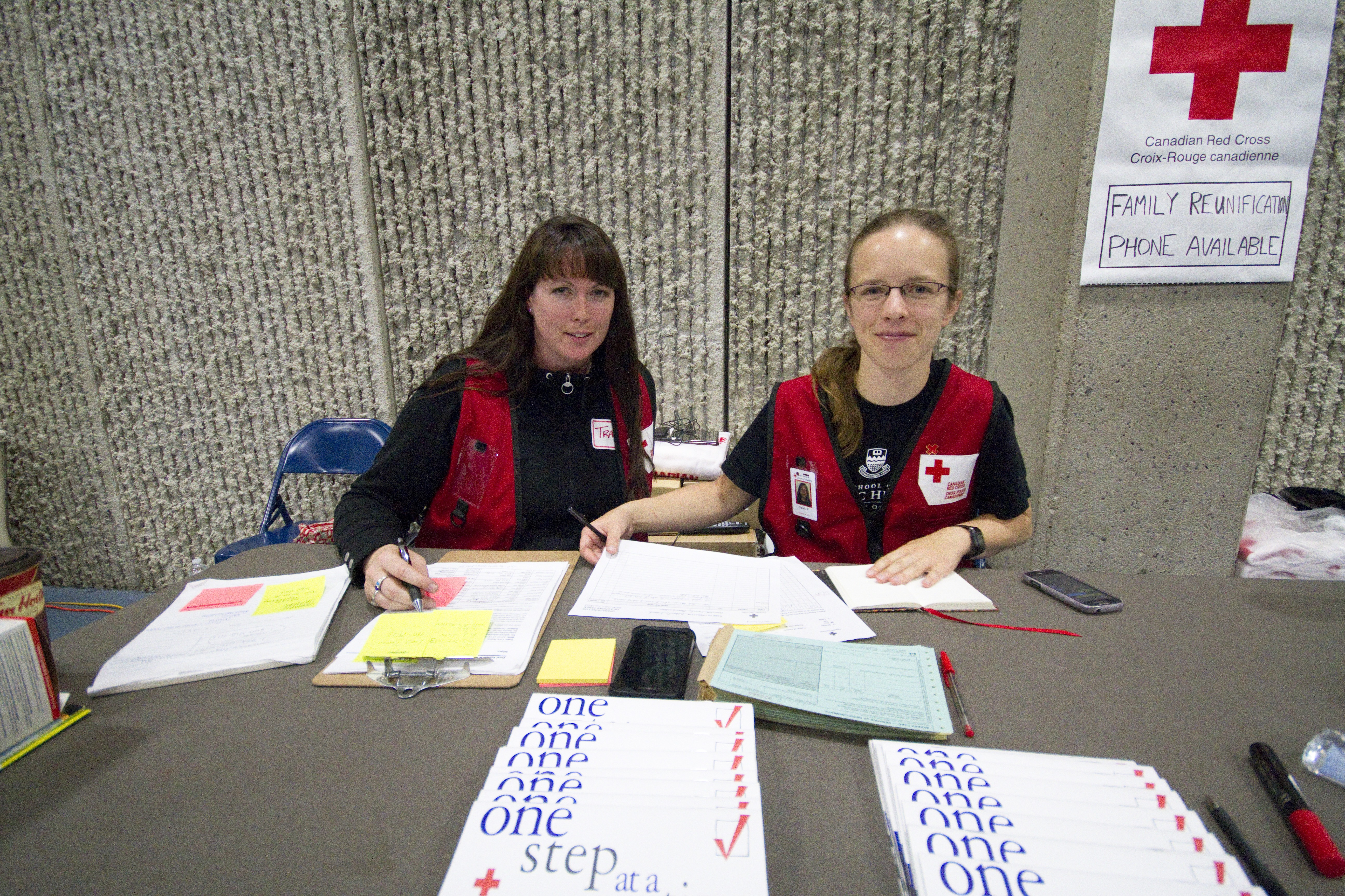 (L-R) Volunteers Tracy Warrington and Sarah Flynn are working the family reunification table at Southland Leisure Centre.
