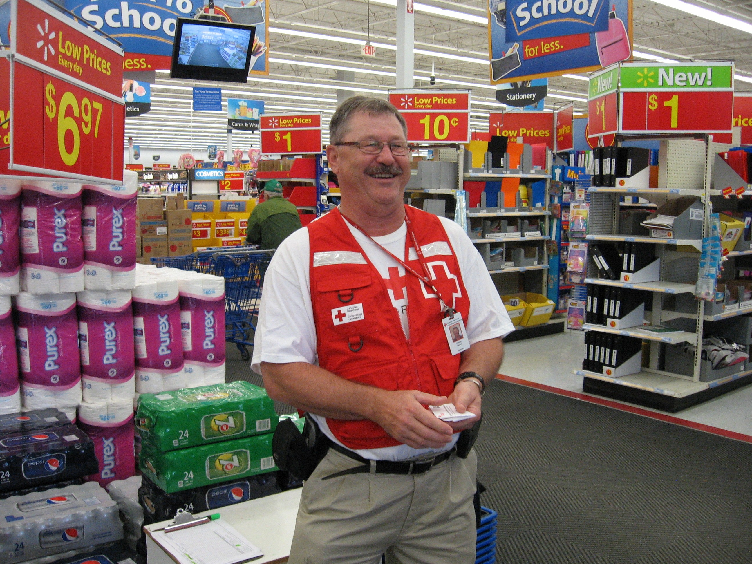 Weyburn, SK – Canadian Red Cross volunteer helping and greeting Walmart customers