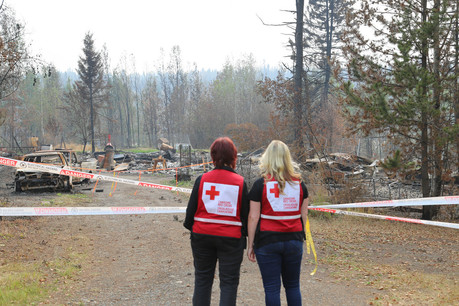 Red Cross workers look at damage from BC wildfires
