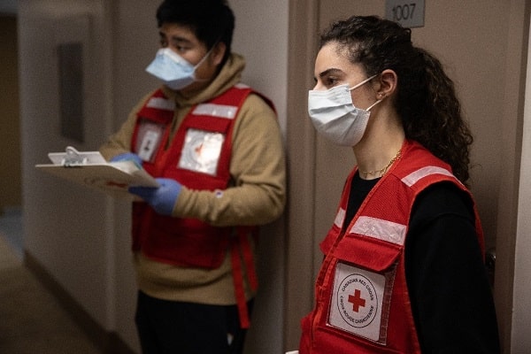 Canadian Red Cross volunteers making wellness checks on residents.