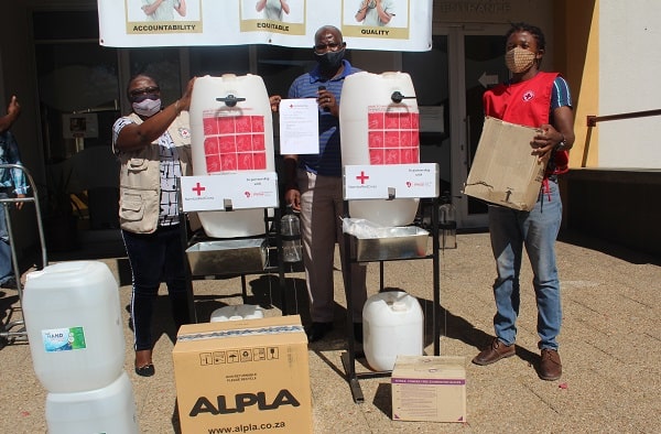 Members of Namibia Red Cross standing at a handwashing station